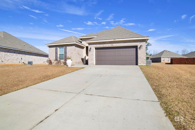 view of front facade featuring central AC unit, a garage, and a front lawn