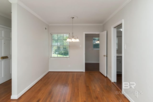 2105 Upham Pl, Mobile, AL 36607 - unfurnished dining area featuring wood finished floors, a chandelier, crown molding, and baseboards