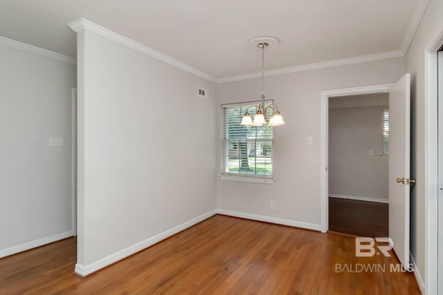2105 Upham Pl, Mobile, AL 36607 - empty room featuring wood finished floors, a chandelier, ornamental molding, and baseboards