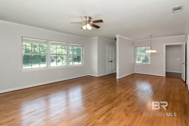 2105 Upham Pl, Mobile, AL 36607 - spare room with a chandelier, ceiling fan, light wood finished floors, baseboards, and crown molding