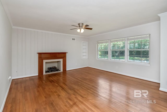 2105 Upham Pl, Mobile, AL 36607 - unfurnished living room featuring ceiling fan, crown molding, wood finished floors, baseboards, and a fireplace