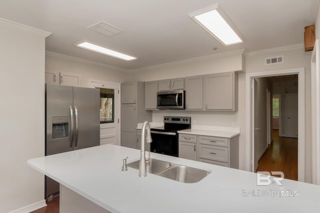 2105 Upham Pl, Mobile, AL 36607 - kitchen with appliances with stainless steel finishes, gray cabinets, a sink, crown molding, and dark wood-style flooring