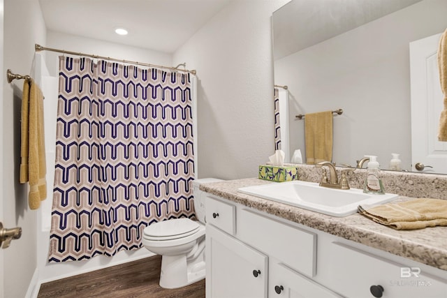 22894 Ridgewood Dr, Robertsdale, AL 36567 - bathroom featuring vanity, wood finished floors, toilet, and shower / tub combo