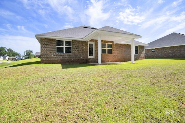 22894 Ridgewood Dr, Robertsdale, AL 36567 - back of house with a yard, brick siding, and roof with shingles