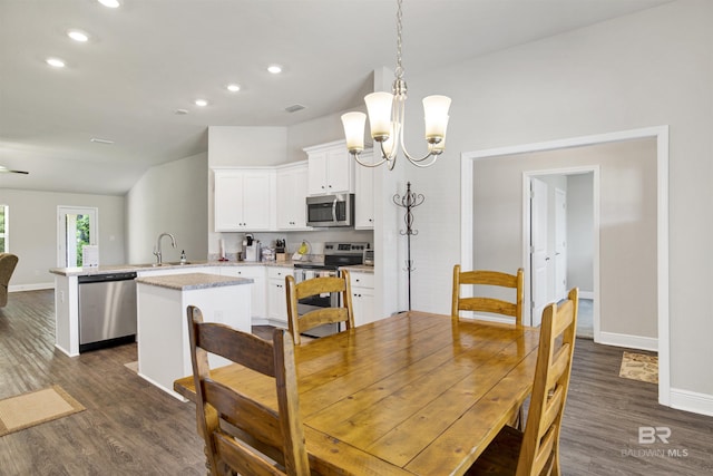 22894 Ridgewood Dr, Robertsdale, AL 36567 - dining space with dark wood-style flooring, baseboards, a chandelier, recessed lighting, and vaulted ceiling
