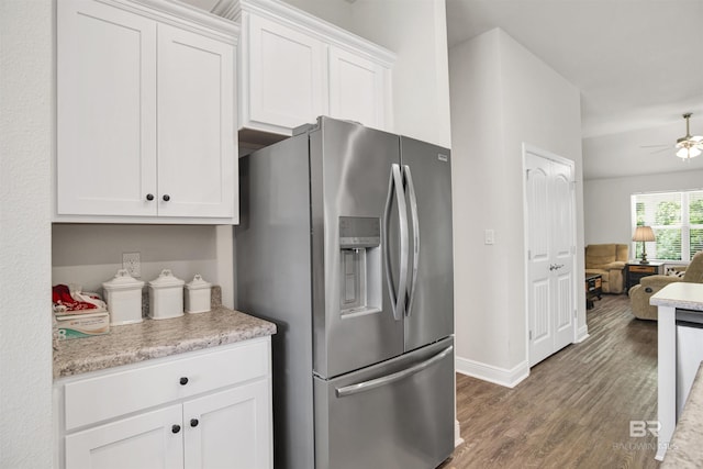 22894 Ridgewood Dr, Robertsdale, AL 36567 - kitchen with stainless steel fridge with ice dispenser, ceiling fan, wood finished floors, white cabinetry, and baseboards