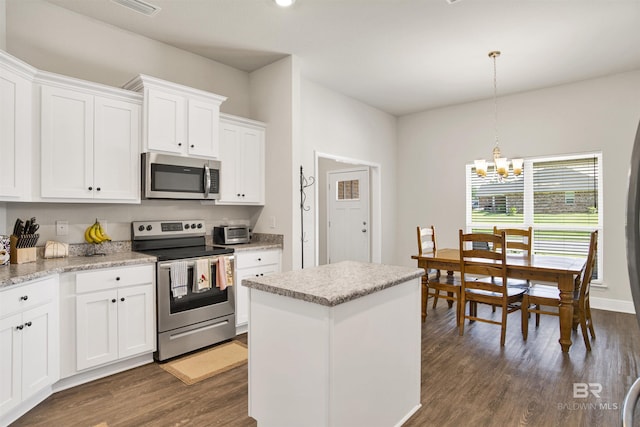 22894 Ridgewood Dr, Robertsdale, AL 36567 - kitchen with appliances with stainless steel finishes, a chandelier, dark wood finished floors, and white cabinets