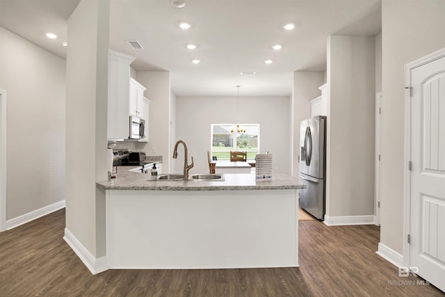 22894 Ridgewood Dr, Robertsdale, AL 36567 - kitchen with appliances with stainless steel finishes, a peninsula, a sink, white cabinets, and dark wood-style flooring