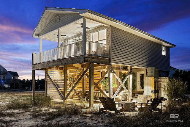 property exterior at dusk featuring ceiling fan