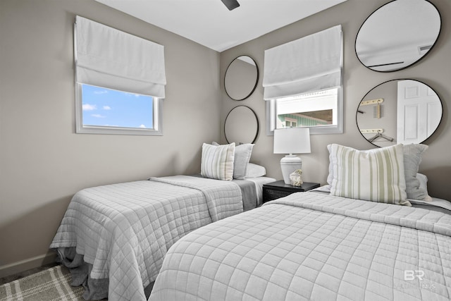 bedroom featuring multiple windows and ceiling fan