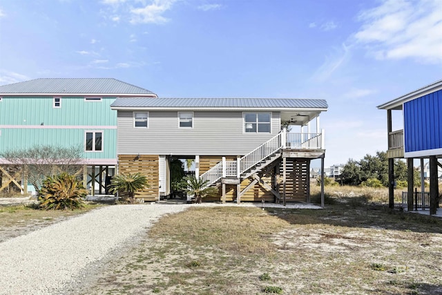 raised beach house with ceiling fan and a porch