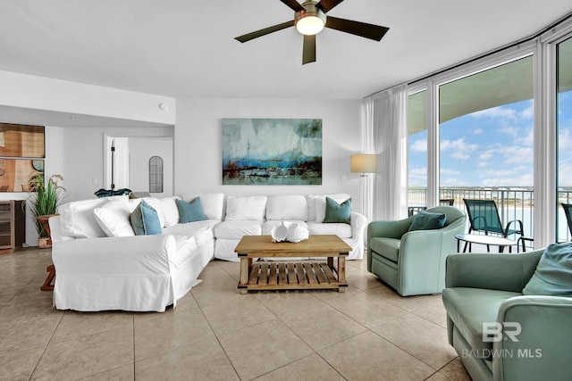 living room with wine cooler, ceiling fan, floor to ceiling windows, and light tile patterned floors