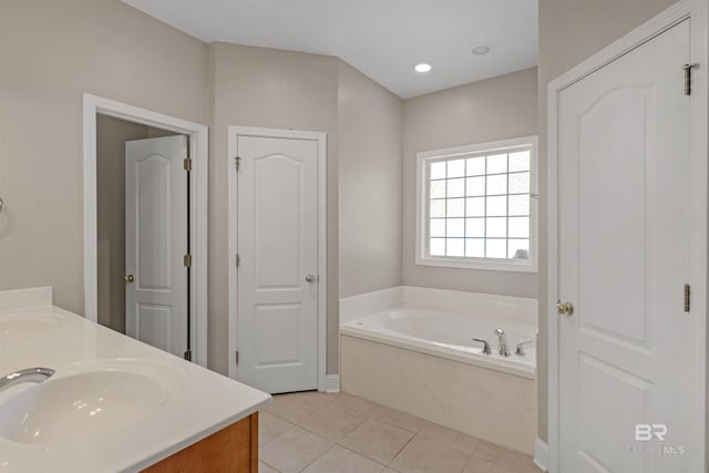 bathroom featuring vanity, tile patterned floors, and a bathing tub