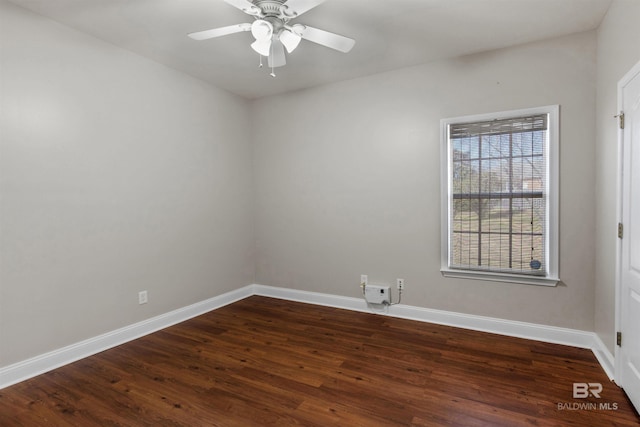 spare room with ceiling fan and dark hardwood / wood-style flooring