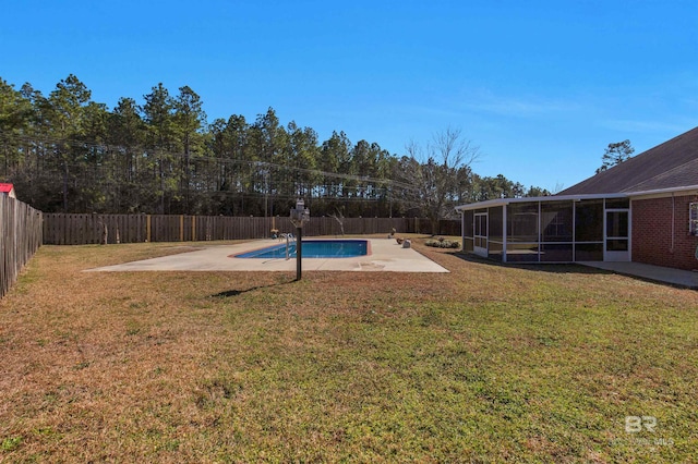 view of swimming pool with a yard, a sunroom, and a patio