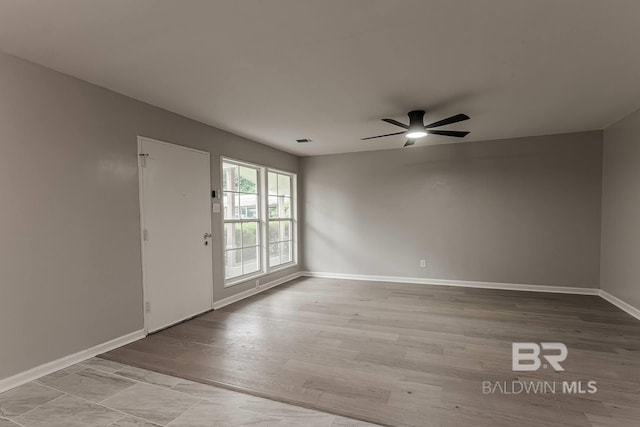 spare room featuring ceiling fan and light hardwood / wood-style floors