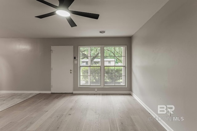 spare room featuring light hardwood / wood-style flooring and ceiling fan