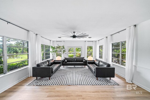 sunroom with a healthy amount of sunlight and ceiling fan