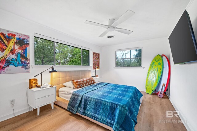 bedroom with light hardwood / wood-style flooring and ceiling fan