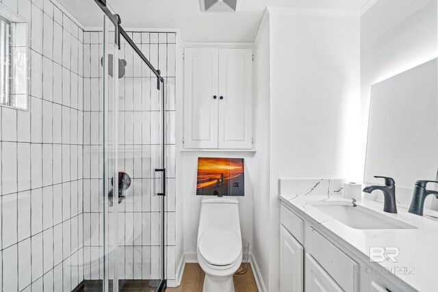 bathroom featuring crown molding, an enclosed shower, toilet, vanity, and hardwood / wood-style flooring