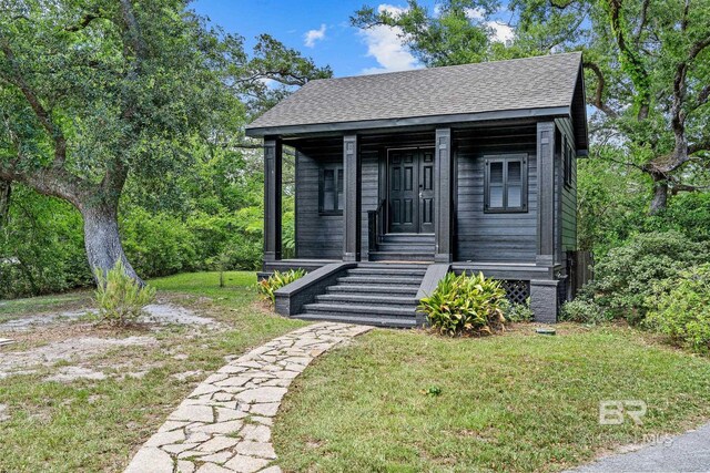 bungalow-style house with a porch and a front yard