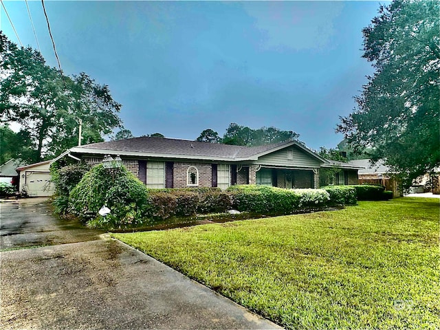 view of front of home with a front yard and a garage