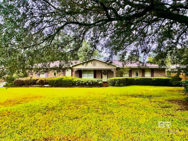 single story home featuring a front lawn and brick siding