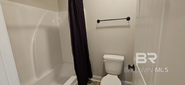 bathroom with bathtub / shower combination and toilet