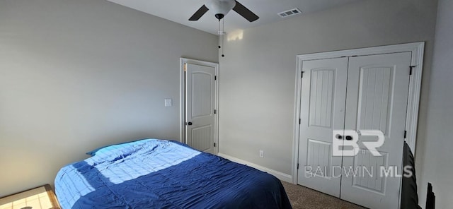 carpeted bedroom featuring a closet and ceiling fan