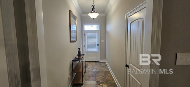 interior space with dark tile patterned floors and ornamental molding