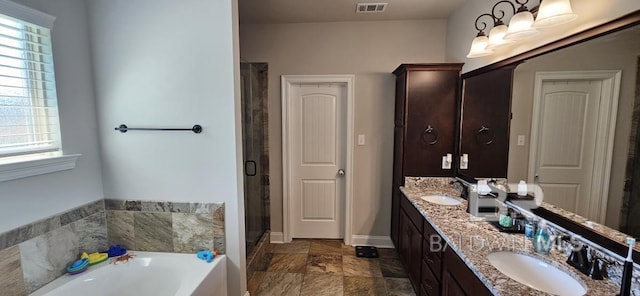 bathroom featuring dual vanity, shower with separate bathtub, and tile patterned floors