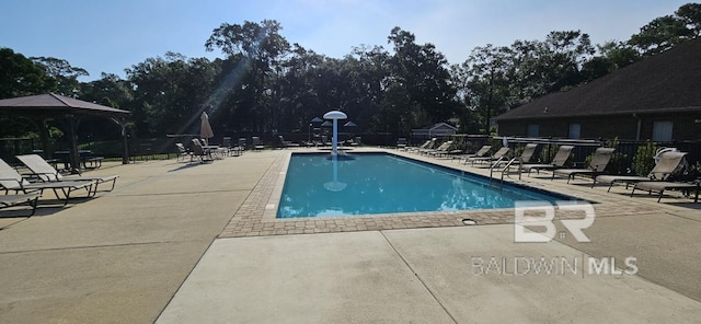 view of swimming pool with a patio area and a gazebo