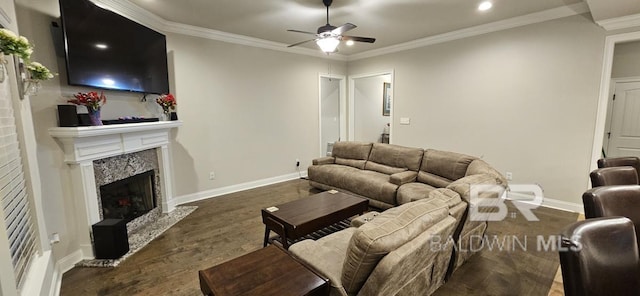 living room with dark hardwood / wood-style flooring, ornamental molding, a high end fireplace, and ceiling fan