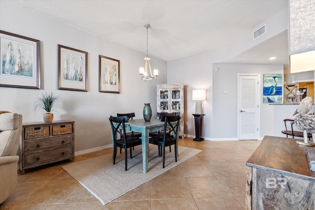 dining room with light tile patterned floors, an inviting chandelier, visible vents, and baseboards