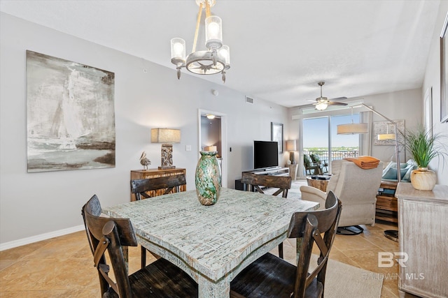 dining room featuring baseboards, visible vents, and ceiling fan with notable chandelier