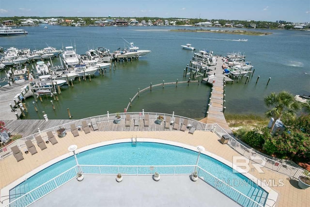 view of pool featuring a boat dock and a water view