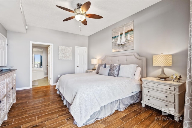 bedroom with ensuite bathroom, a ceiling fan, wood tiled floor, a textured ceiling, and baseboards