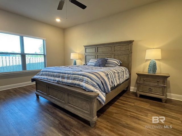 bedroom with ceiling fan and dark wood-type flooring