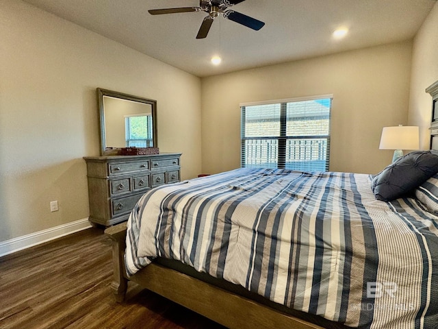 bedroom with dark hardwood / wood-style floors and ceiling fan