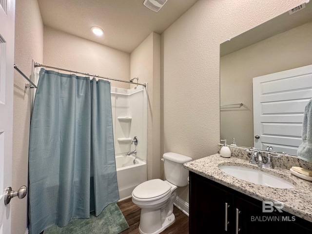 full bathroom with wood-type flooring, vanity, toilet, and shower / bath combo with shower curtain