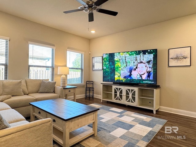 living room featuring ceiling fan and dark hardwood / wood-style flooring