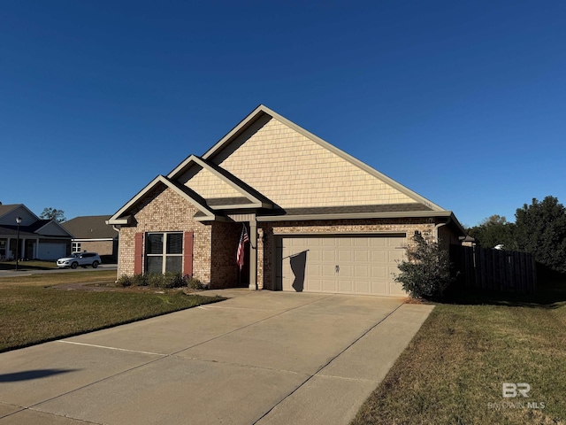 craftsman inspired home featuring a garage and a front lawn