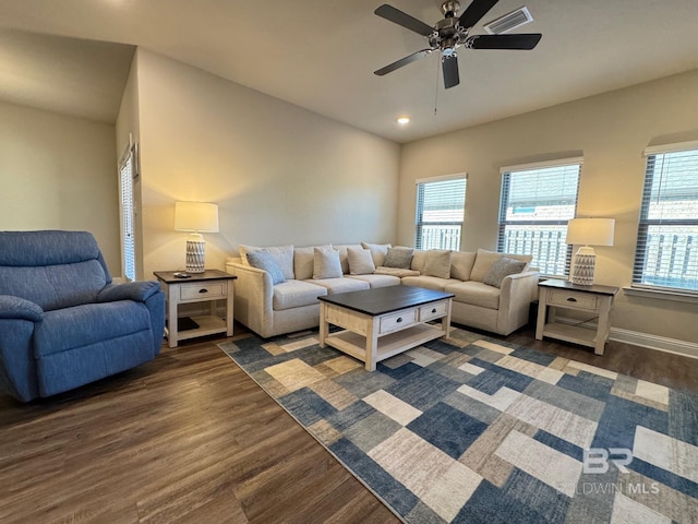 living room featuring dark hardwood / wood-style flooring, plenty of natural light, and ceiling fan