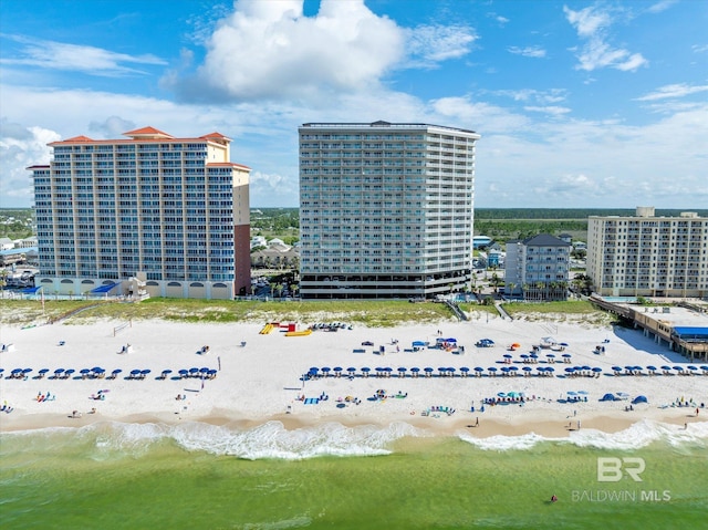 drone / aerial view featuring a view of the beach and a water view