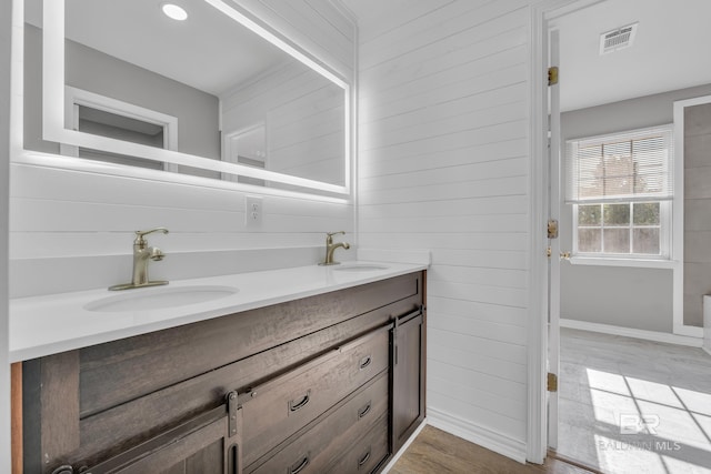 24477 Harvester Dr, Loxley, AL 36551 - bathroom featuring double vanity, baseboards, a sink, and wood finished floors