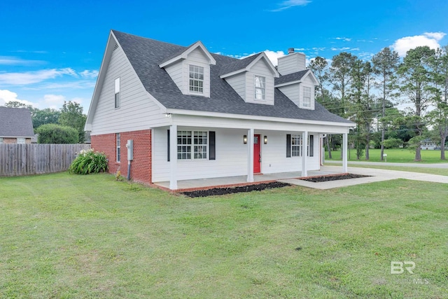 24477 Harvester Dr, Loxley, AL 36551 - cape cod-style house with fence, a chimney, a front lawn, and brick siding