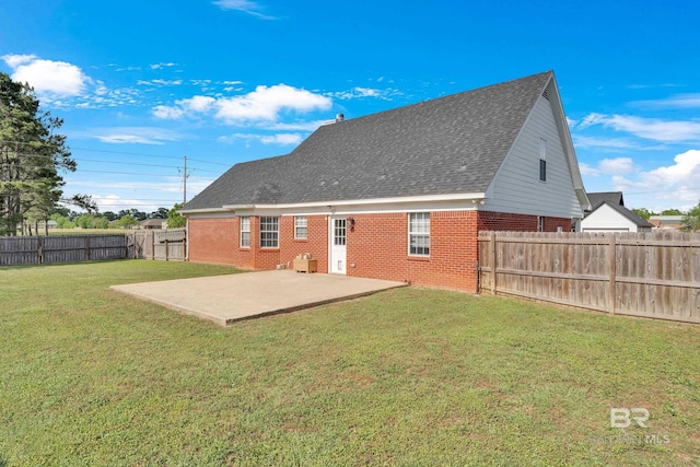 24477 Harvester Dr, Loxley, AL 36551 - back of property featuring a patio, a shingled roof, a yard, and brick siding