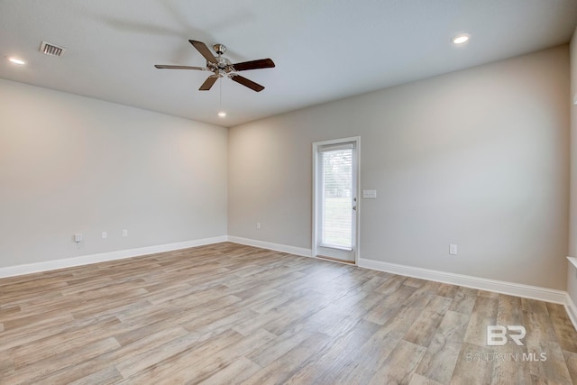 empty room featuring light hardwood / wood-style flooring and ceiling fan