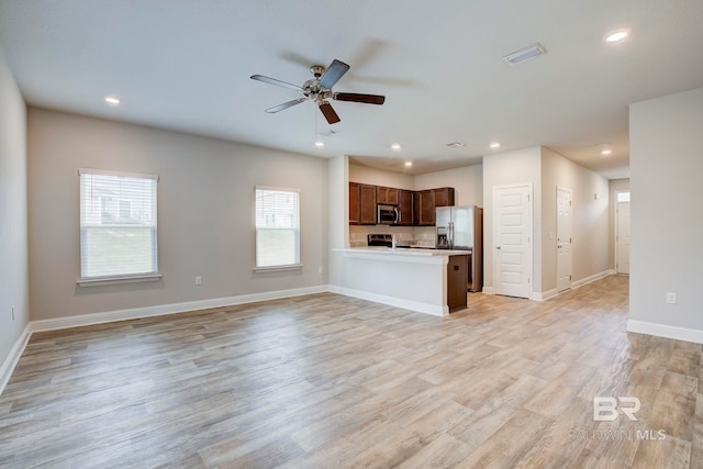 unfurnished living room with ceiling fan and light hardwood / wood-style floors