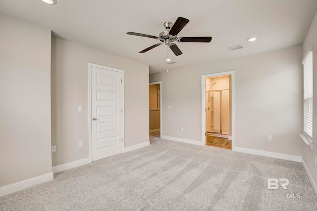 unfurnished bedroom featuring ensuite bathroom, a closet, ceiling fan, and light colored carpet